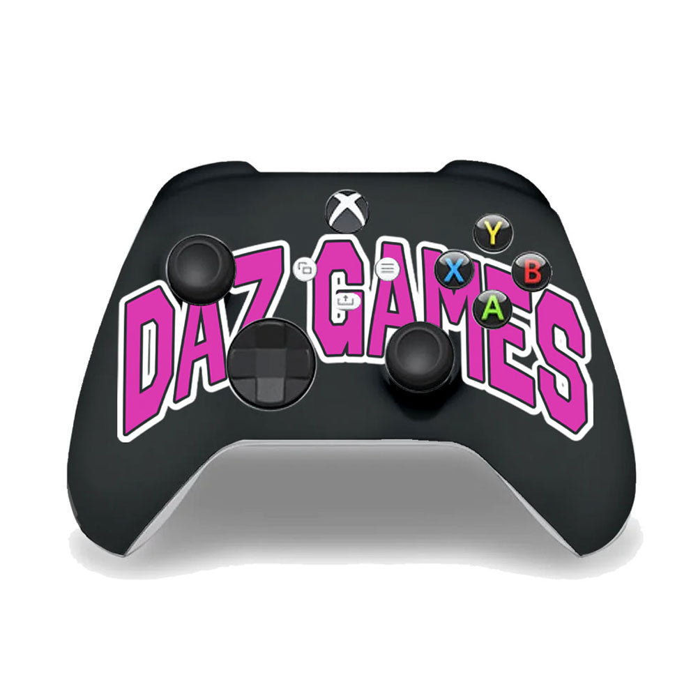 Xbox controller with ’DAZ GAMES’ written in pink lettering across the front.