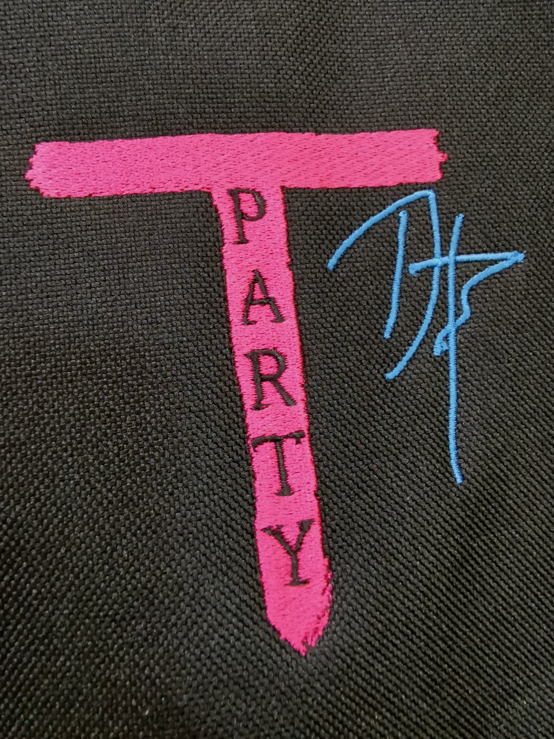 Pink T-shaped text reading ’PARTY’ with blue scribble-like markings next to it.